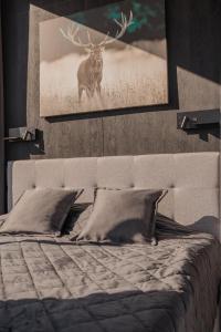 a bedroom with a bed with a picture of a deer at Pulli Country Club in Pärnu