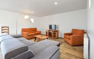 a living room with a couch and two chairs at Maison De Charme Proche Mer in Saint-Germain-de-Tournebut