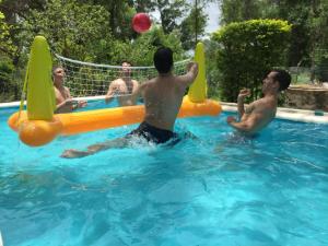 a group of men playing in a swimming pool at Casa de Verano en Ypacarai con lago natural, Piscina, Naturaleza y Comodidad para Grupos in Ypacarai +26 photos