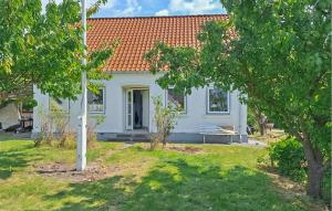 a white house with a bench in a yard at Beautiful Home In Ærøskøbing in Bro +8 photos