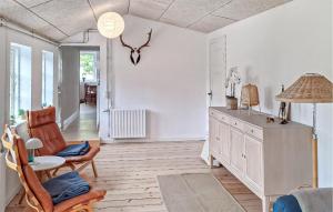 a living room with white walls and a table and chairs at Beautiful Home In Ærøskøbing in Bro
