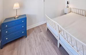 a bedroom with a blue bed and a blue dresser at Beautiful Home In Ærøskøbing in Bro