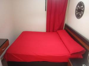 a red bed with a red curtain in a room at بلوباى آسيا العين السخنه in Ain Sokhna
