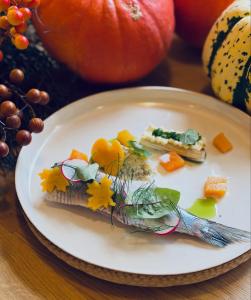 a white plate with food on a table at Hotel Boss in Łódź