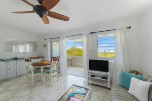 a living room with a couch and a table at Rum Runner - Golden View 328 in Saint James