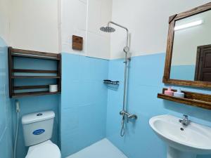 a bathroom with a white toilet and a sink at An Homestay 2 in Phan Thiet