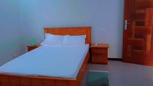 a bedroom with a large bed with a wooden headboard at Chez Philo et Marc in Somone +26 photos