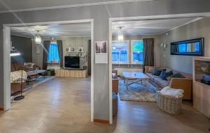 a living room with a couch and a table at Cozy Home In Flekkefjord With House Sea View in Flekkefjord