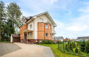 a large house with a fence in front of it at Stunning Apartment In Jastrzebia Gora With Sauna in Tupadły