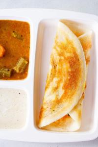 a plate of food with a tortilla and a bowl of soup at Hotel Granton in Hyderabad