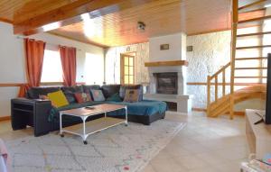 a living room with a couch and a fireplace at Three Bedroom Lovely Home In Joganville in Joganville