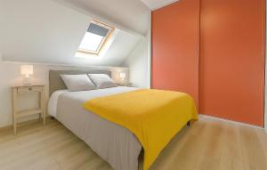 a bedroom with a bed with a yellow blanket on it at Three Bedroom Lovely Home In Joganville in Joganville