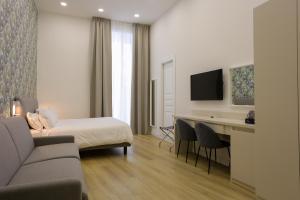 a hotel room with a bed and a desk at Elysium Relais in Naples