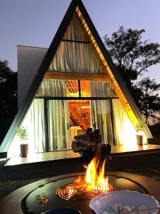 a fire pit in front of a house at Chale Blue Lodge in São Pedro