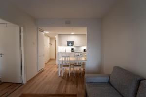a living room with a couch and a table at Snowflake X in Rovaniemi +6 photos