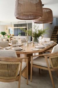 a dining room with a wooden table and chairs at Nalu Villa in Cape Town