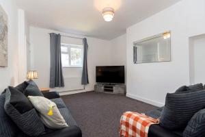 a living room with a couch and a flat screen tv at 2-Bed House•Free Parking•WiFi•Long Stays Welcome in Ferryhill