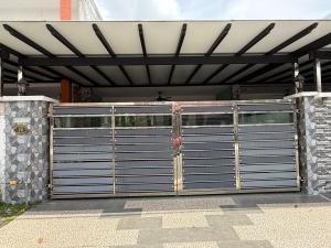 a metal garage door with awning on a house at Iskandar Puteri Ensuite Room in Gelang Patah +6 photos