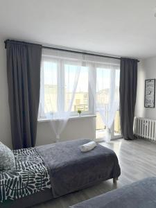 En eller flere senge i et værelse på 03 Gdynia Centrum - Apartament Mieszkanie dla 2 os