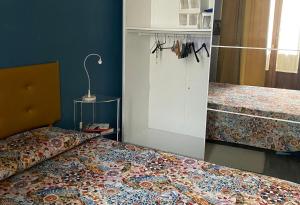 a bedroom with two beds and a cabinet with a bed sidx sidx at Pinerolo medievale in Pinerolo