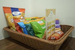 a basket filled with different types of chips at Grace Residency Chennai Airport in Chennai