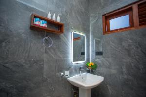 a bathroom with a sink and a mirror at Villa Claudia Nimal's kitchen in Ahangama
