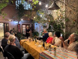 a group of people sitting at a table in a restaurant at Lina's Tango Guesthouse in Buenos Aires