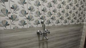 a pair of scissors in front of a wall at Aruna homes Thanjavur in Thanjāvūr