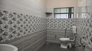 a bathroom with a toilet and a sink at Aruna homes Thanjavur in Thanjāvūr
