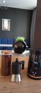 a kitchen counter with a coffee maker and a blender at Rembrandt Hostel in Kraków