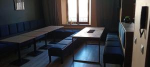 a restaurant with tables and benches and a window at Rembrandt Hostel in Kraków +10 photos