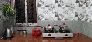 a stove with pots and pans on top of it at Peace Abode Vista in Dibrugarh +52 photos