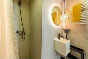 a bathroom with a sink and a mirror at Typical Lisbon center in Lisbon +21 photos