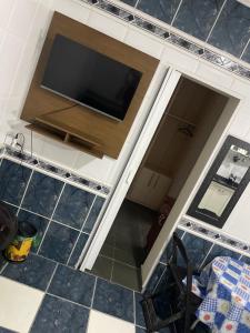 a view from above of a kitchen with a flat screen tv at Albuquerque nro36 casa 3 in Campinas