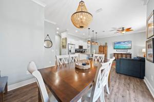 a dining room and living room with a table and chairs at Latitudes ‘N Attitudes in Gulf Shores +34 photos