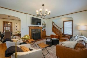 a living room with a couch and a fireplace at Riggs House Restored 1908 Home in Maquoketa