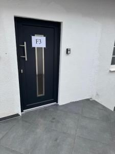 a blue door with a sign that says on it at F3 - 1 Zimmer Wohnung in Offenbach