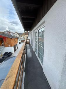 a balcony with a wooden bench on a building at F3 - 1 Zimmer Wohnung in Offenbach +11 photos