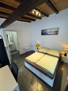 a bedroom with a bed and a table and a tv at F3 - 1 Zimmer Wohnung in Offenbach
