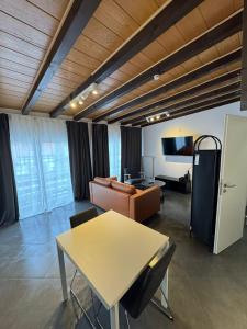 a living room with a table and a couch at F3 - 1 Zimmer Wohnung in Offenbach +10 photos
