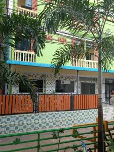 a building with a bench in front of a building at Natcha Place Klongluang 35 in Ban Bang Khan
