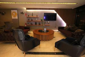 a living room with couches and a tv at Best Western Izmir Hotel in İzmir
