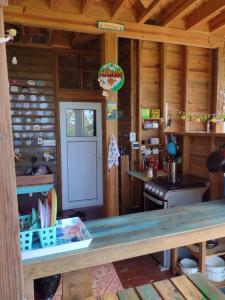 a kitchen in a log cabin with a counter top at Runaway Pineapple Lodge in Mangrove Bight