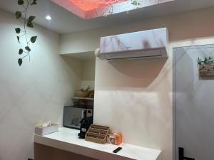 a small kitchen with a counter and a microwave at Love room - 5 min train station - Jacuzzi - Netflix - Clim in Avignon