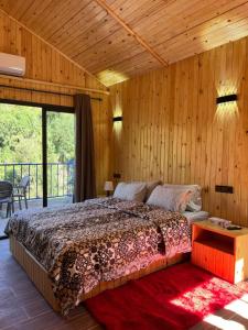 a bedroom with a bed in a room with wooden walls at Top Ourika in Aghbalou