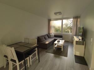 a living room with a couch and a table at P Armino in Marijampolė