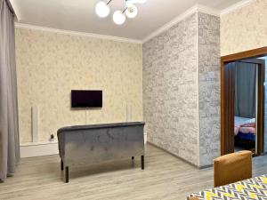 a bedroom with a bed and a flat screen tv at Romantic place in Darkhon