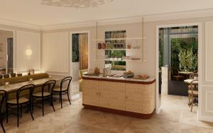 a kitchen and dining room with a table and chairs at Hôtel Almarine Eiffel by Malone in Paris