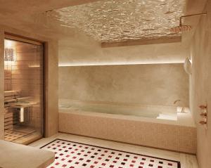 a bathroom with a bath tub in a room at Hôtel Almarine Eiffel by Malone in Paris