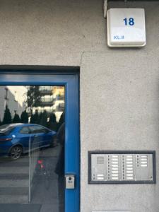 a door to a building with a sign on it at Ruczaj Cozy Room in Krakow